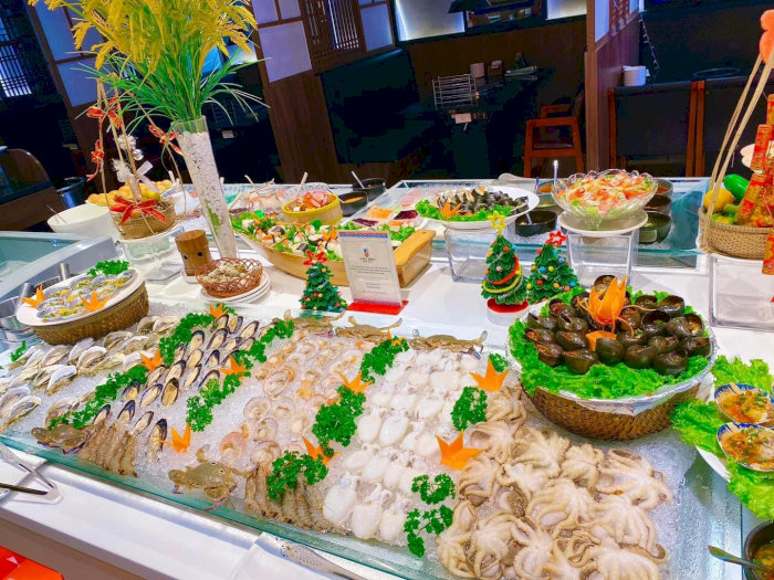 Quầy buffet hải sản đa dạng với bạch tuộc, ốc, sò, tôm bày trí bắt mắt trên đá lạnh kèm trang trí Noel.